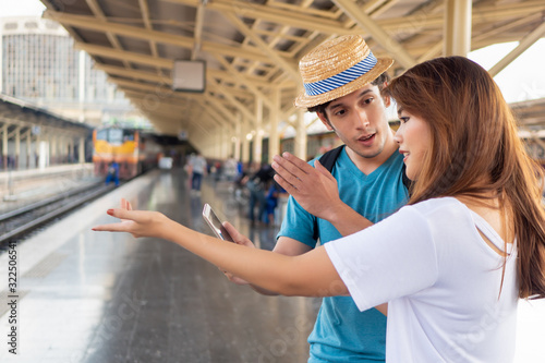 Fotografie Asian woman speaking fluent foreign language with foreigner; concept of communic