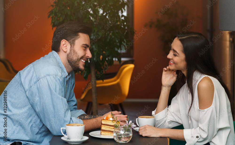 Millennial Couple In Love Talking Sitting In Coffee Shop Millennial Couple In Love Talking Sitting In Coffee Shop