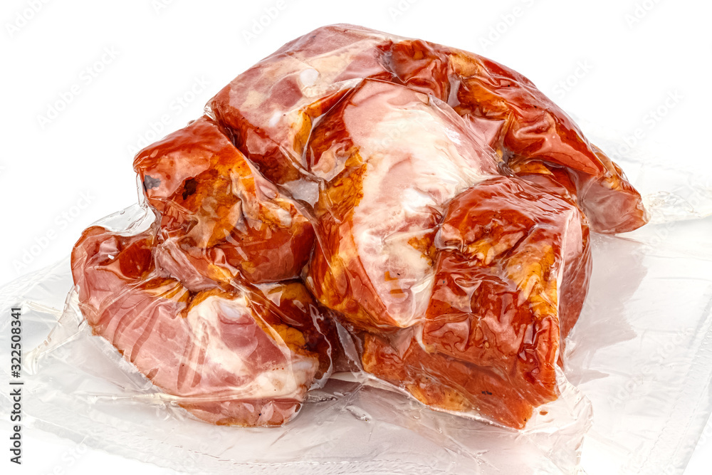 Boiled and smoked meat on ribs in a transparent vacuum package isolated on white background Boiled and smoked meat on ribs in a transparent vacuum package isolated on white background