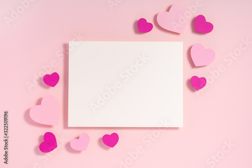 Valentine hearts with shadow, blank sheet of paper, template for design on pink surface © Aisland