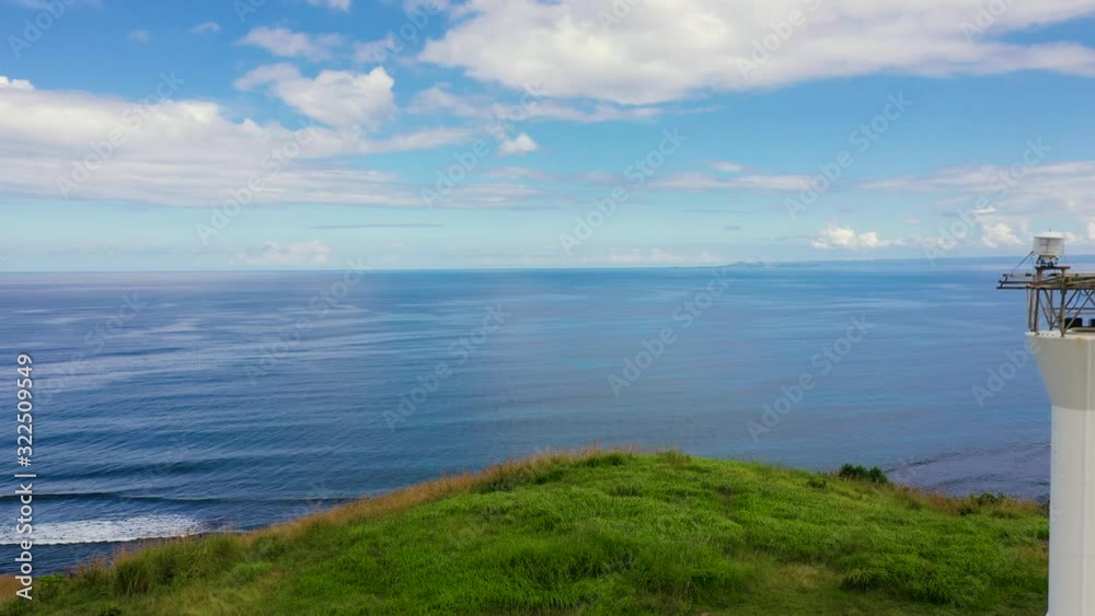 Lighthouse on a tropical island, view from above. Beautiful landscape with a green island. Basot Island, Caramoan, Camarines Sur, Philippines. Lighthouse on a tropical island, view from above. Beautiful landscape with a green island. Basot Island, Caramoan, Camarines Sur, Philippines.