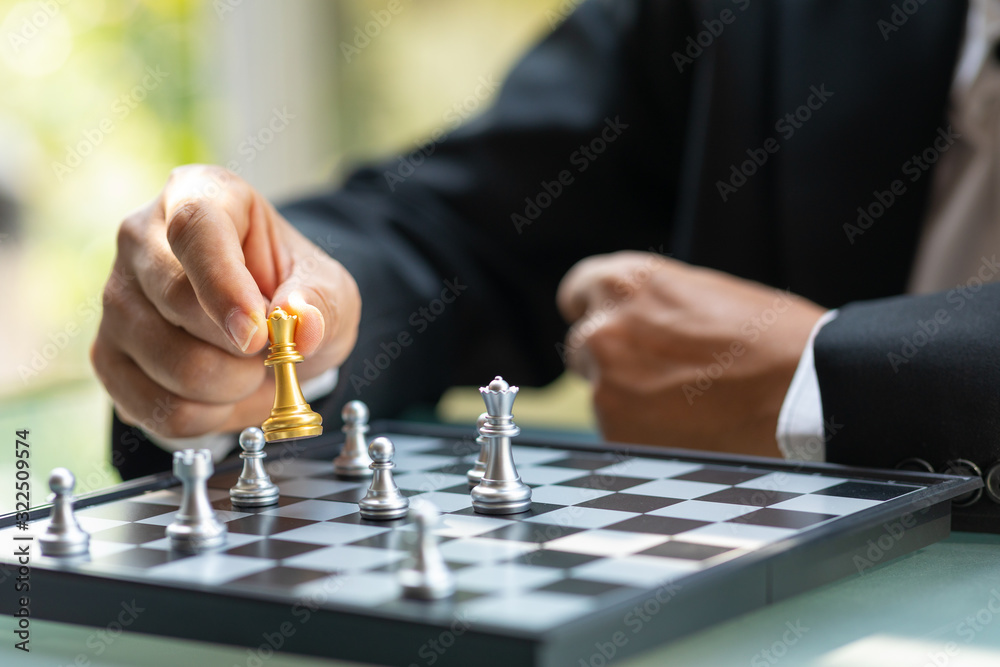 Business man holding The king chess for finishing the game Business man holding The king chess for finishing the game