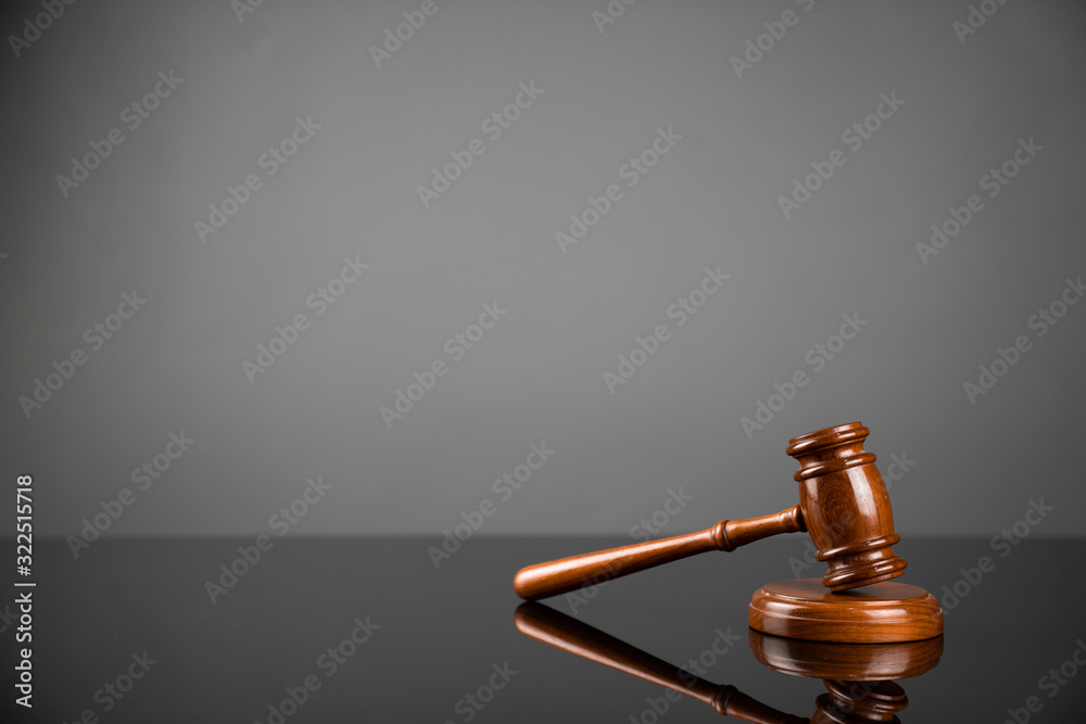 Gavel on gray background. Law, auction and business concept.  