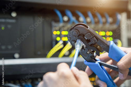 Male hand preparing a Lan Cable. photo