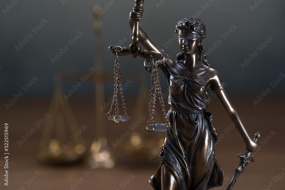 The Statue of Justice or lady justice / Justitia the Roman goddess of Justice in lawyers office The Statue of Justice or lady justice / Justitia the Roman goddess of Justice in lawyers office