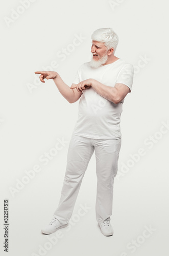 Smiling albino man pointing away