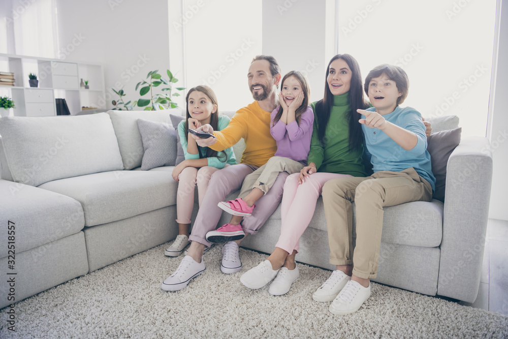 Dream harmony full family concept. Five people dad daddy mom mommy sit comfort couch watch cartoons little preteen schoolboy point index finger in room house Dream harmony full family concept. Five people dad daddy mom mommy sit comfort couch watch cartoons little preteen schoolboy point index finger in room house