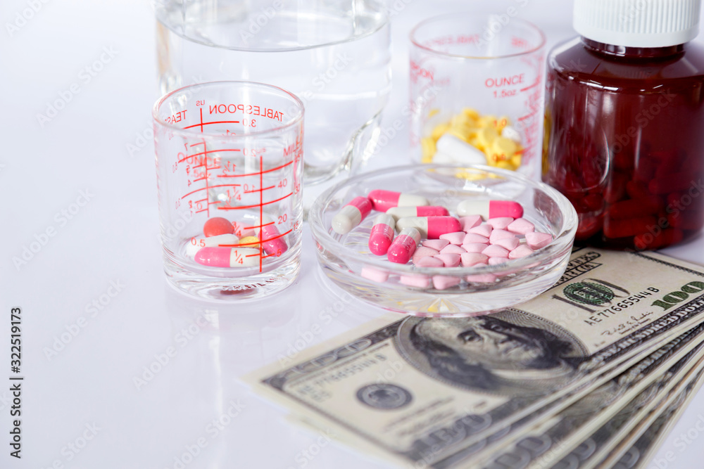 Medicine pills or Capsules with Money, dollar Medical or pharmacy prescription for health. Business, finance concept. Cost of the healthy life. Medicine pills or Capsules with Money, dollar Medical or pharmacy prescription for health. Business, finance concept. Cost of the healthy life.