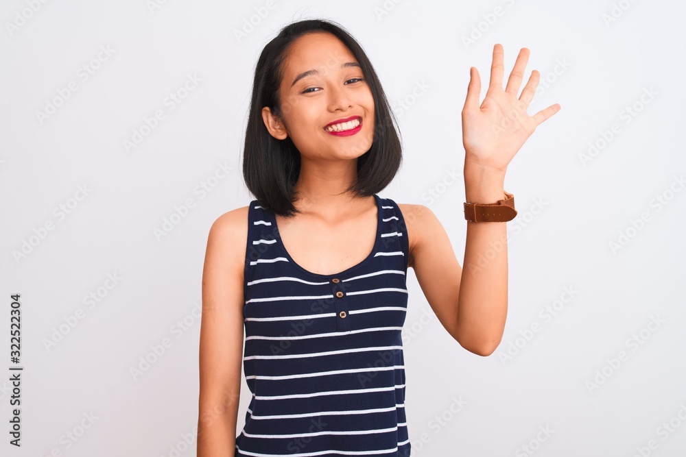 Young chinese woman wearing striped t-shirt standing over isolated white background showing and pointing up with fingers number five while smiling confident and happy. Young chinese woman wearing striped t-shirt standing over isolated white background showing and pointing up with fingers number five while smiling confident and happy.