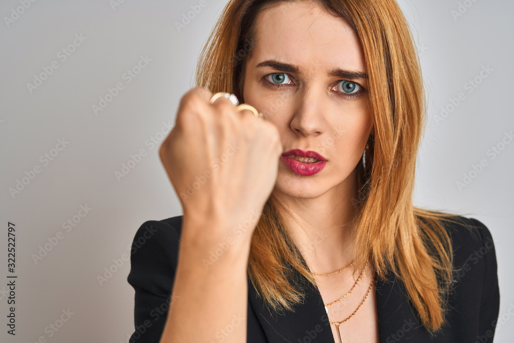 Close up of caucasian elegant business woman over isolated background annoyed and frustrated shouting with anger, crazy and yelling with raised hand, anger concept Close up of caucasian elegant business woman over isolated background annoyed and frustrated shouting with anger, crazy and yelling with raised hand, anger concept
