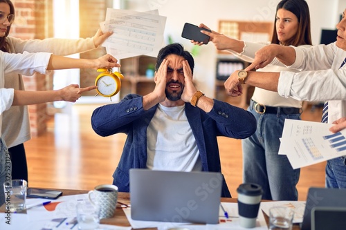 Group of business workers working together. Partners stressing one of them at the office