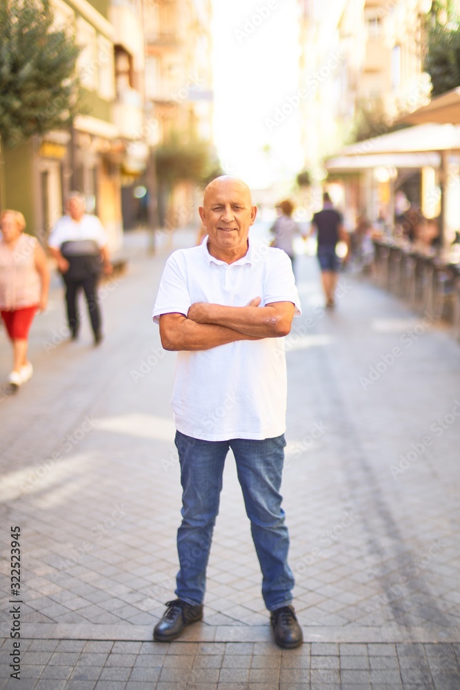 Senior handsome man smiling happy and confident. Standing with smile on face at town street Senior handsome man smiling happy and confident. Standing with smile on face at town street