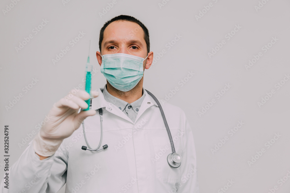 Male doctor with syringe and stethoscope.  Coronavirus epidemic concept.