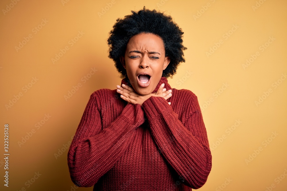 Young beautiful African American afro woman with curly hair wearing casual turtleneck sweater shouting suffocate because painful strangle. Health problem. Asphyxiate and suicide concept. Young beautiful African American afro woman with curly hair wearing casual turtleneck sweater shouting suffocate because painful strangle. Health problem. Asphyxiate and suicide concept.