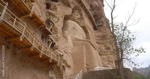 Ancient Chinese Buddha Statue at Bingling Cave Temple in Gansu China. UNESCO World heritage site photo