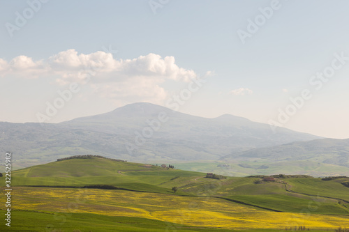 Beautiful Tuscany landscape in spring time with wave green hills and isolated trees and farmhouses. Tuscany  Italy  Europe