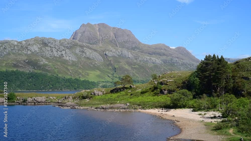 Panning shot of Loch Maree and the mountain Slioch, Wester Ross, Scottish Highlands, Scotland, UK Panning shot of Loch Maree and the mountain Slioch, Wester Ross, Scottish Highlands, Scotland, UK