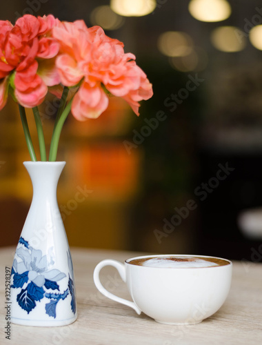 Coffee cup with hearts on old table photo