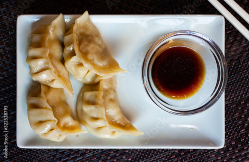 Japanese tasty dumplings gyozas with soy sauce photo