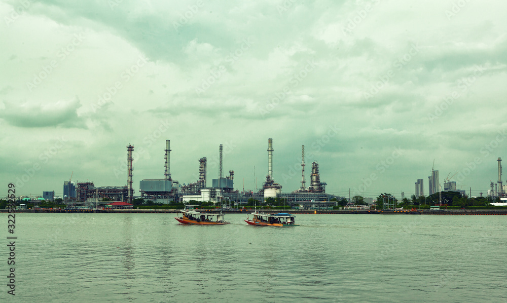 a standard and eco-friendly refinery, surrounded by rivers and sky, covered with clouds.
