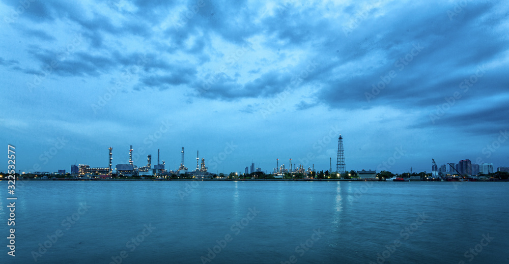 Oil refinery environmentally friendly, with sky and clouds, river