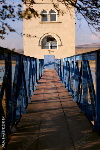 Blue bridge leading to abandoned building