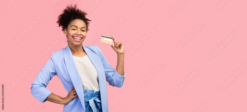 Black woman holding credit card and looking at camera Black woman holding credit card and looking at camera