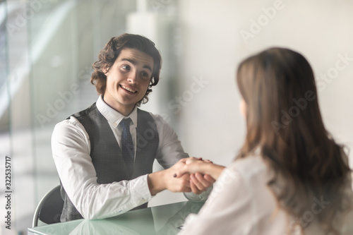 Businessman and businesswoman shaking hands in the office
