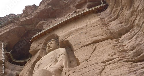 Ancient Chinese Buddha Statue at Bingling Cave Temple in Gansu China. UNESCO World heritage site photo