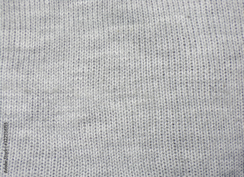 Background of a hand-knitted white jacket. Warm winter sweater.