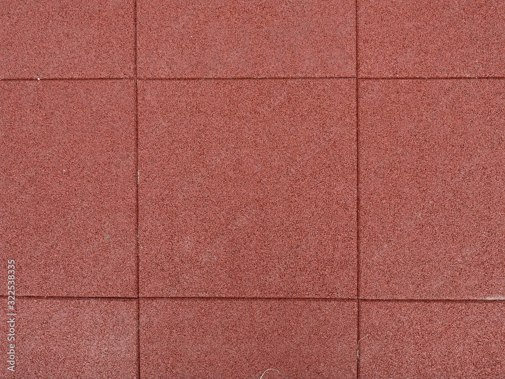Fototapeta premium Texture of red rubber floor used for safety kids playground