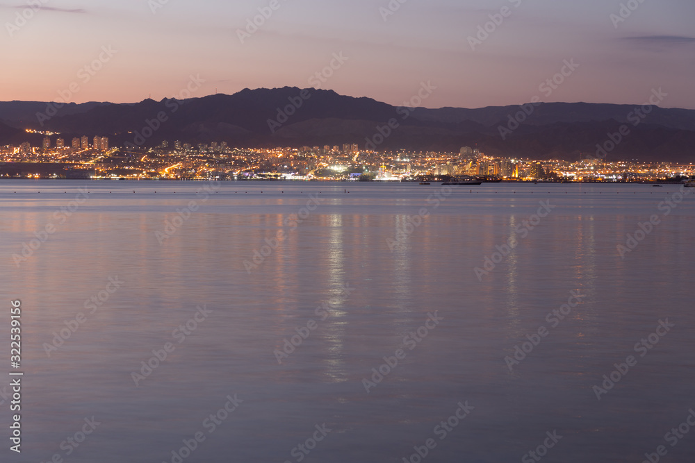 Sunset in Aqaba city, view of Eilat city in Israel. Aqaba city, Jordan