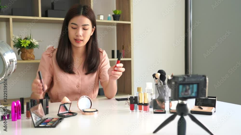 4k video of asian woman present beauty cosmetic product and broadcast live video to social network by internet at home, beauty blogger concept.