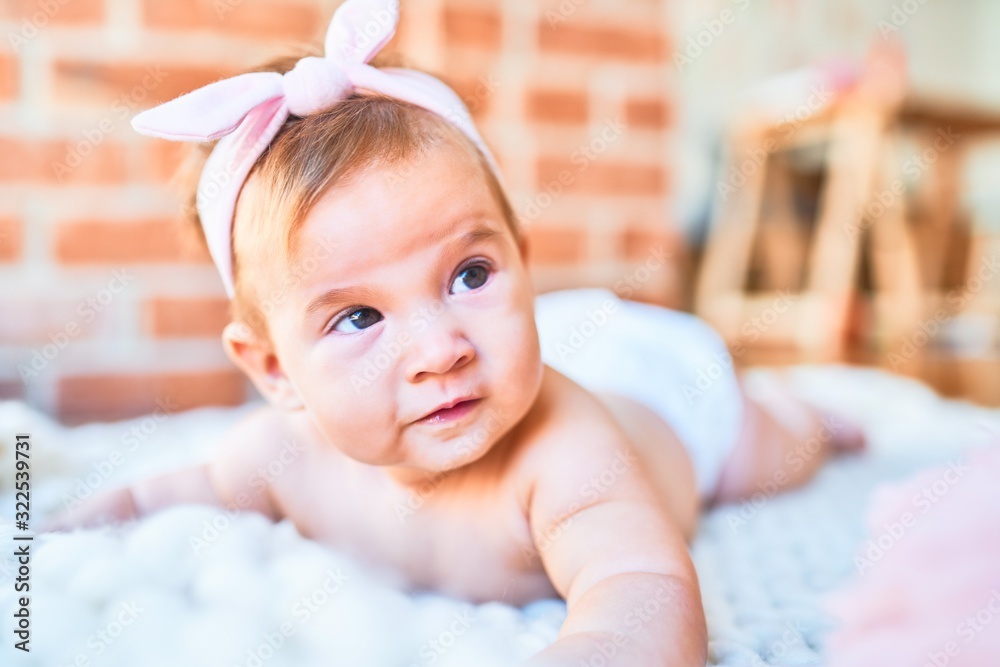 Adorable baby lying down over blanket on the floor at home. Newborn relaxing and resting comfortable Adorable baby lying down over blanket on the floor at home. Newborn relaxing and resting comfortable
