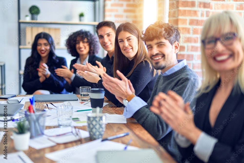 Group of business workers smiling happy and confident. Working together with smile on face looking at the camera applauding at the office Group of business workers smiling happy and confident. Working together with smile on face looking at the camera applauding at the office