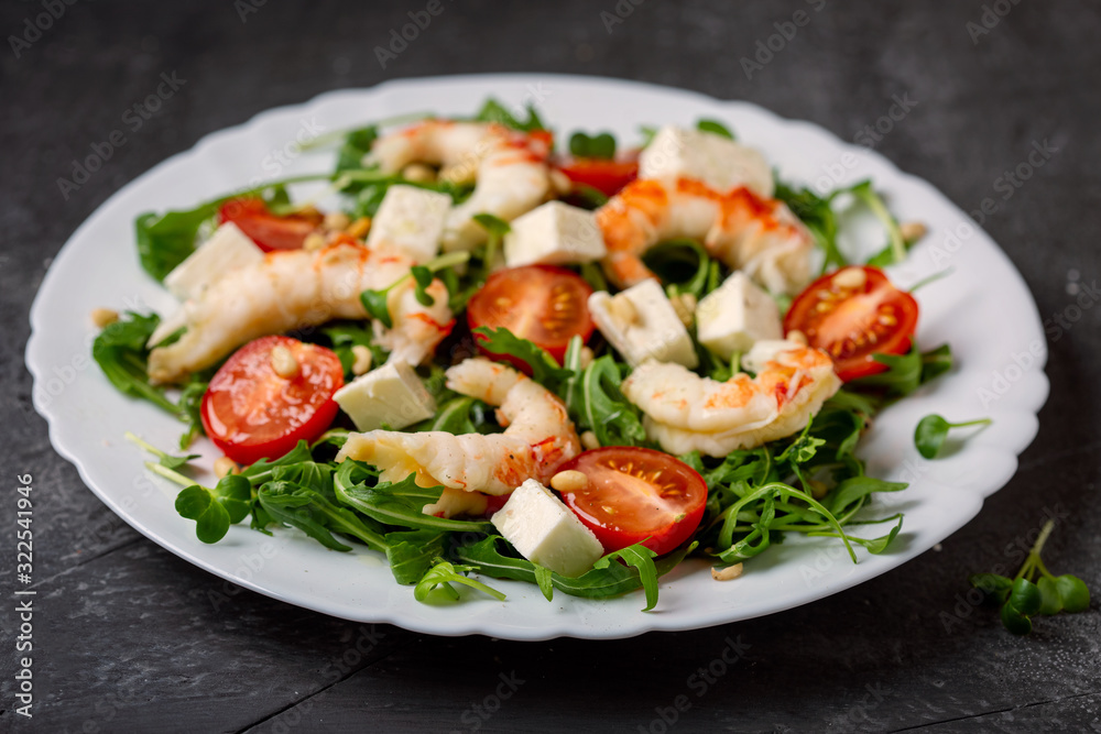 Salad with arugula, shrimp, cheese and fresh tomatoes Salad with arugula, shrimp, cheese and fresh tomatoes