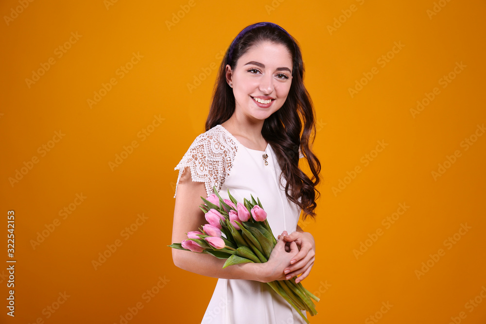 Beautiful female holding bouquet of springtime flowers for international women's day holiday.