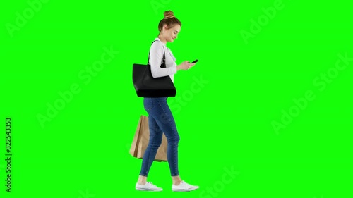 Woman Checking Her Phone While Walking Home Back From Shopping Green Screen
