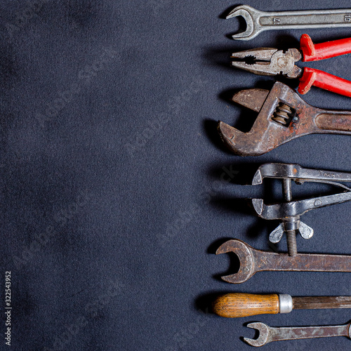 Tools for repair and reconstruction in home conditions lie on a black background