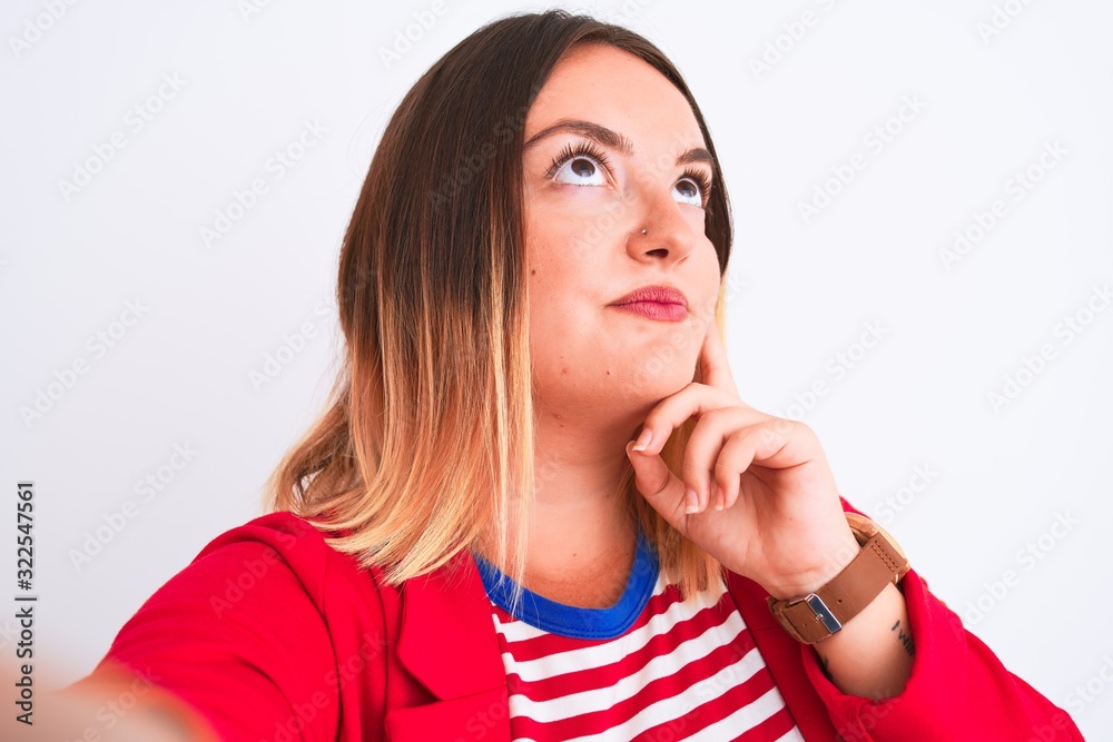 Beautiful woman wearing striped t-shirt and jacket standing over isolated white background serious face thinking about question, very confused idea Beautiful woman wearing striped t-shirt and jacket standing over isolated white background serious face thinking about question, very confused idea
