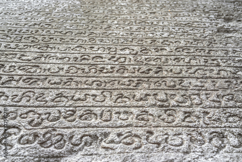 Sinhalese language stone book on wall of 12th century stone Hindu structure. Polonnaruwa, Sri Lanka. UNESCO World heritage Site. photo