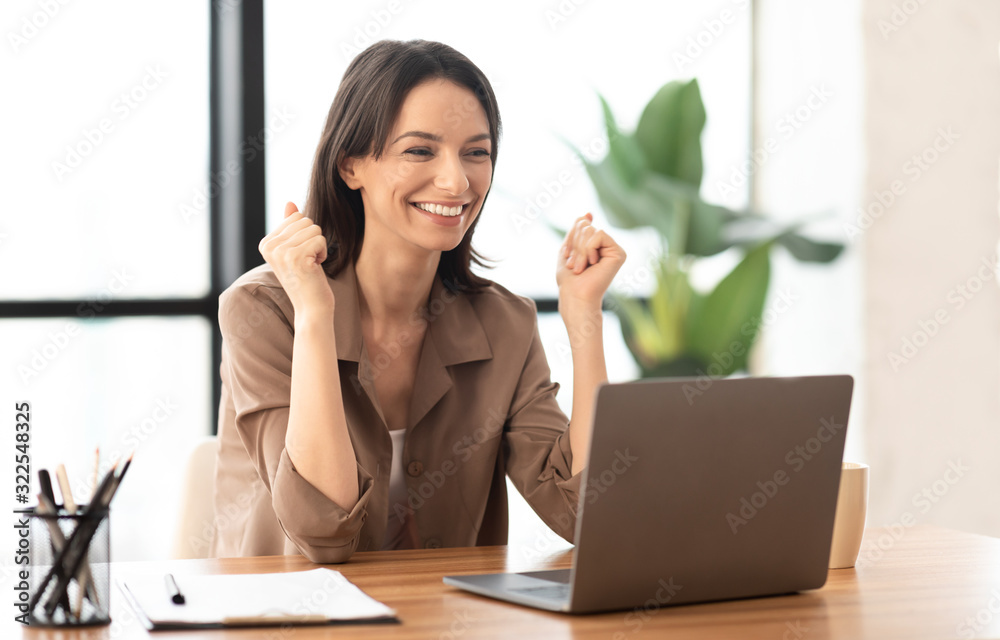 Excited manager celebrating her victory at work Excited manager celebrating her victory at work