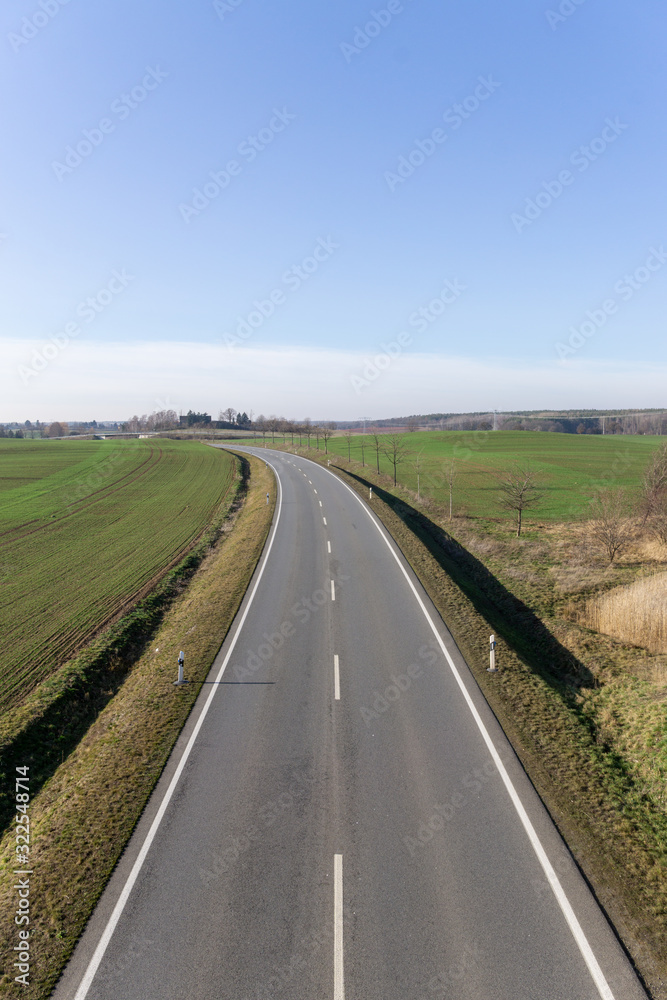 empty asphalt road to the horizon, cloudless blue sky, in Germany near Dresden