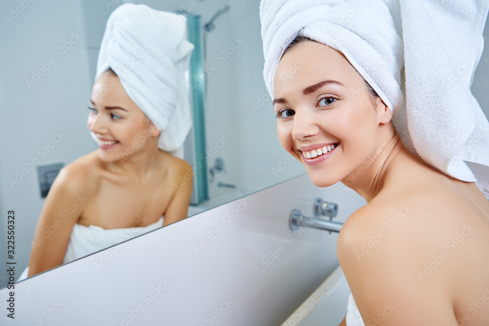 face of young beautiful healthy woman and reflection in the mirror face of young beautiful healthy woman and reflection in the mirror