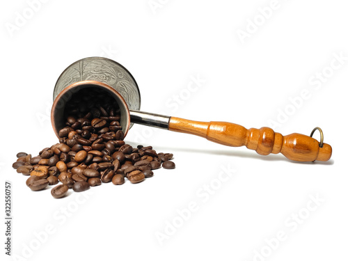 Metal coffee turk with coffee beans isolated on white background. photo
