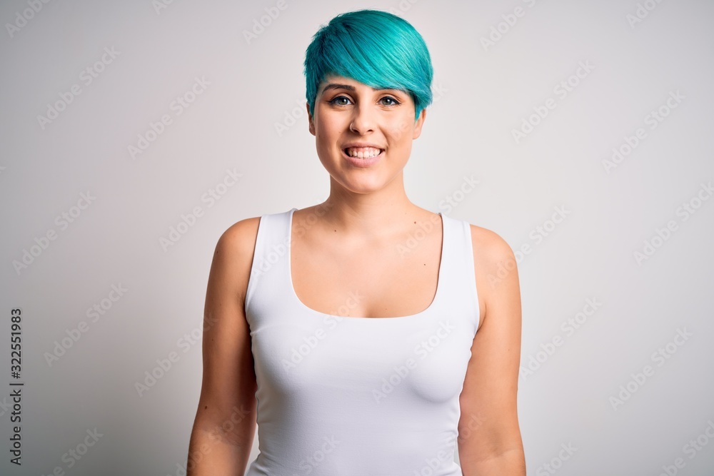 Young beautiful woman with blue fashion hair wearing casual t-shirt over white background with a happy and cool smile on face. Lucky person. Young beautiful woman with blue fashion hair wearing casual t-shirt over white background with a happy and cool smile on face. Lucky person.