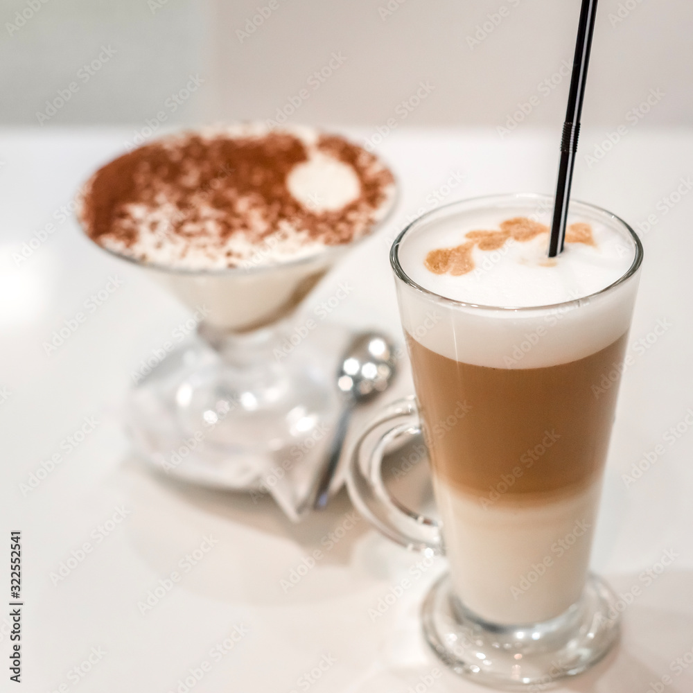 coffee latte with frothy milk in tall glass, rustic style, white background coffee latte with frothy milk in tall glass, rustic style, white background