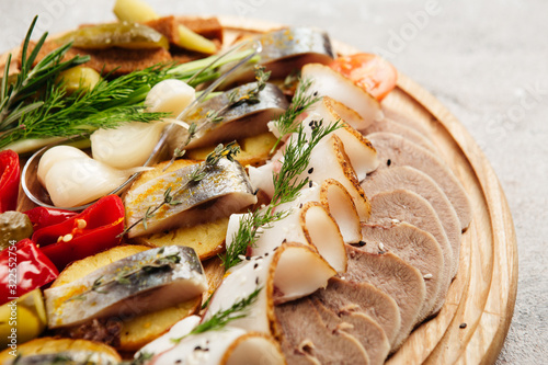 traditional vodka appetizer with herring and beef tongue