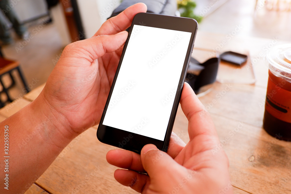 Mockup picture of business man’s hands holding smart phone with white blank screen in modern place. Mockup picture of business man’s hands holding smart phone with white blank screen in modern place.
