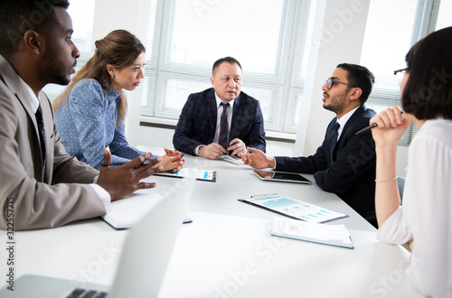 Multy-ethnic group of business people working with computer at office